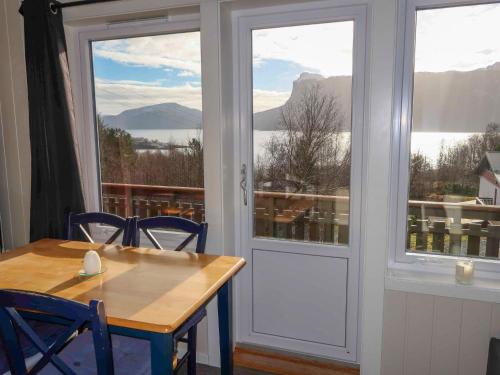 a table and chairs in a room with a window at Holiday Home Havbris - FJS152 by Interhome in Sørbø