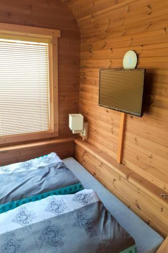 a bedroom with two beds in a wooden cabin at Holiday Home Kemp Stříbrný rybník-9 by Interhome in Hradec Králové