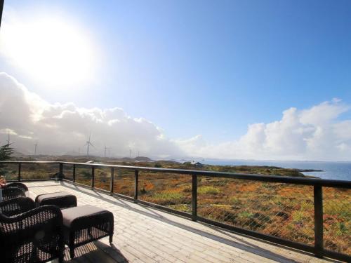 a balcony with benches and a view of the ocean at Holiday Home Havbu by Interhome in Korssund
