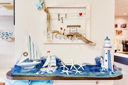 a table topped with figurines of boats and a lighthouse at Hotel Giove in Cesenatico