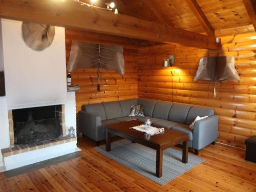 a living room with a couch and a fireplace at Chalet Krampehaugen - FJS046 by Interhome in Utvik