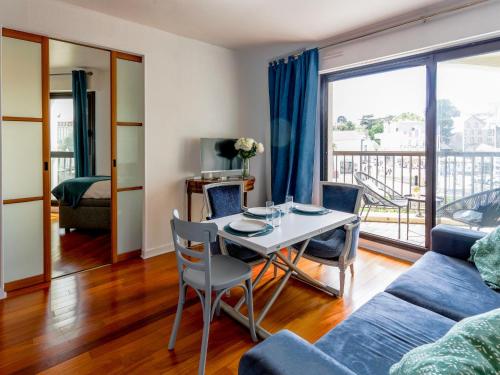 een woonkamer met een tafel en een bank bij Apartment Le Continental by Interhome in Pornic