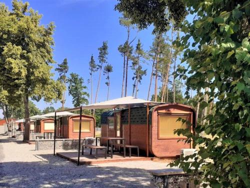 a row of tiny houses with trees in the background at Holiday Home Kemp Stříbrný rybník-7 by Interhome in Hradec Králové