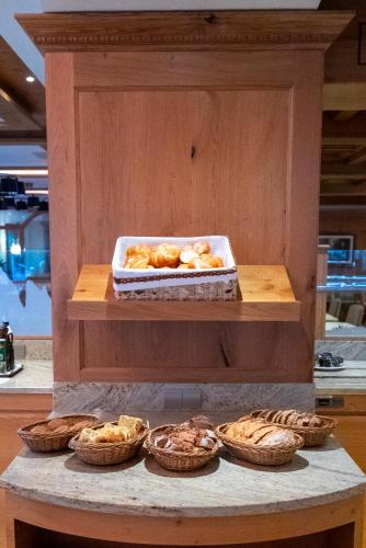 a bunch of pastries sitting on a counter with at Hotel Cesa Tyrol in Canazei