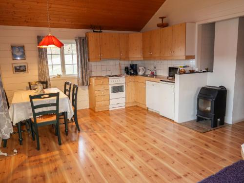 a kitchen and dining room with a table and a stove at Chalet Hagehytta - FJS047 by Interhome in Utvik