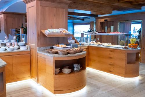 a kitchen with a counter with food on it at Hotel Cesa Tyrol in Canazei