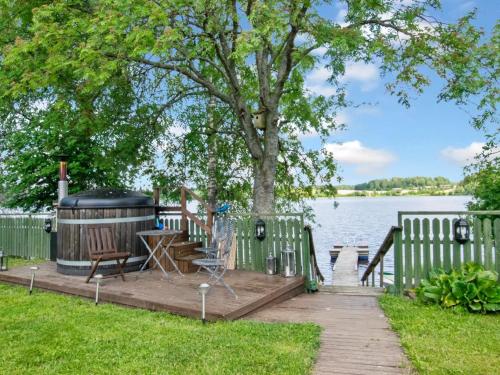 a wooden deck with a tree and aendiaryendiaryendiaryendiaryendiaryendiaryendiaryendiary at Holiday Home Hannula by Interhome in Ikaalinen