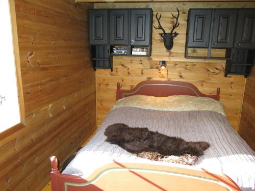 a dog laying on a bed in a room at Chalet Mariabu - SOW142 by Interhome in Fossdal