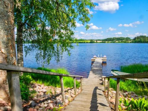 a dock on a lake with two boats on it at Holiday Home Hannula by Interhome in Ikaalinen