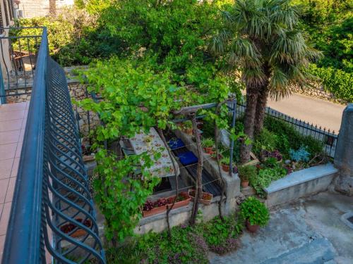 a bunch of plants in a garden next to a fence at Apartment Ivana by Interhome in Jadranovo