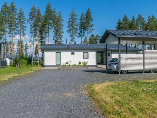 a house with a car parked in front of it at Holiday Home Kuortaneen helmi by Interhome in Kuortane