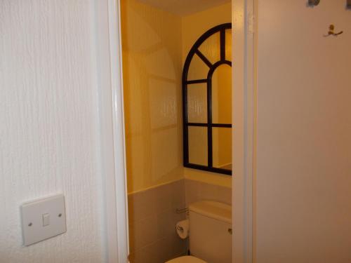 a bathroom with a toilet and a window at Delamere Hotel in Blackpool