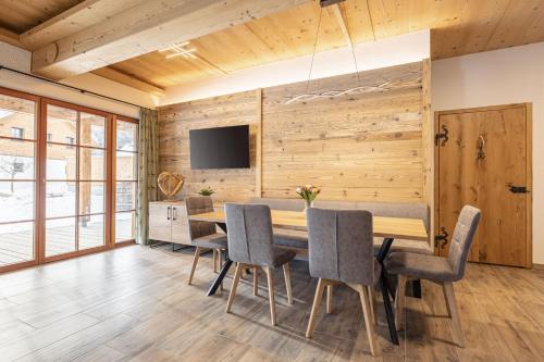 a dining room with a table and chairs at Premium Tauernstyle Golling in Mariapfarr