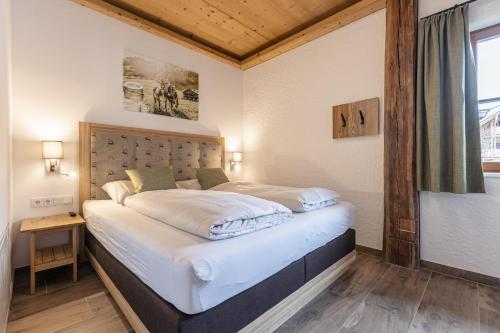 a bedroom with a large bed in a room at Premium Tauernstyle Golling in Mariapfarr