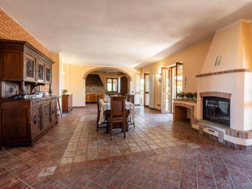 a large living room with a table and a fireplace at Holiday Home Lydia by Interhome in Mombaruzzo