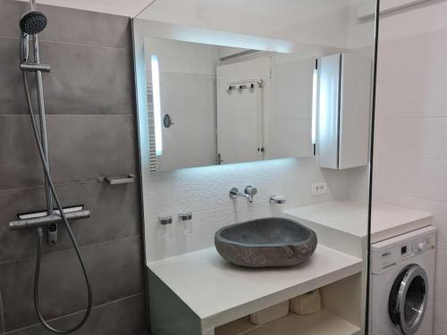 a bathroom with a sink and a shower at La Med in Carry-le-Rouet