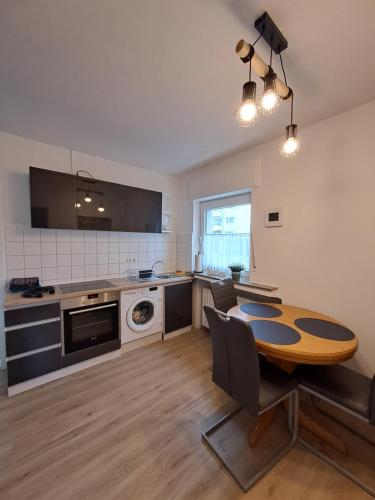 a kitchen with a wooden table and a dining room at Velbert am Berg in Velbert