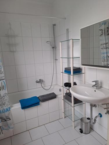 een witte badkamer met een wastafel en een douche bij Velbert am Berg in Velbert