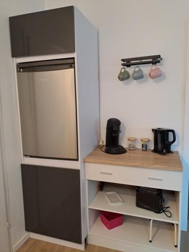 a small kitchen with a refrigerator and a table at Velbert am Berg in Velbert