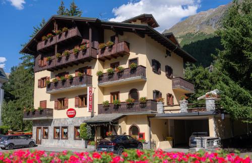 a large building with flowers in front of it at B&B Residence Checrouit in Courmayeur