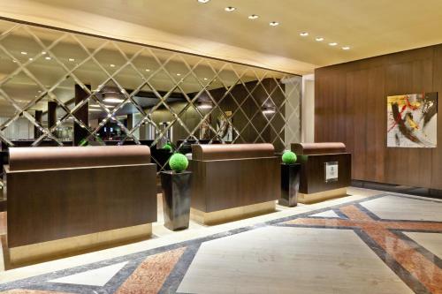 a lobby of a hotel with desks and potted plants at Libertador Hotel in Buenos Aires