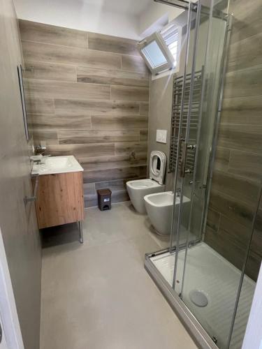 a bathroom with a shower and a sink and a toilet at Casa Vacanze Santa Maria in Santa Maria di Castellabate