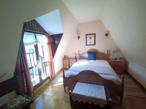ein Schlafzimmer mit einem großen Bett im Dachgeschoss in der Unterkunft Ático en pleno pirineo in El Pueyo de Jaca