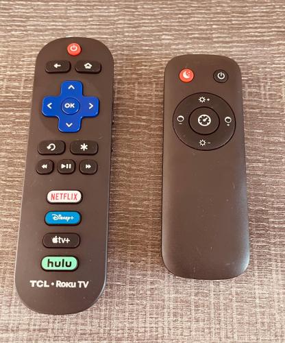 two remote controls sitting next to each other at Summerwind Studios in Fort Myers