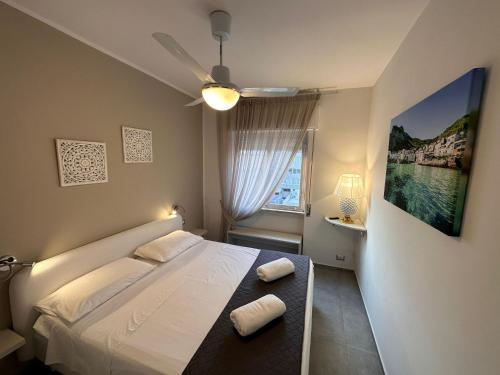 a bedroom with a bed with two towels on it at Luxury Sea House in Trapani