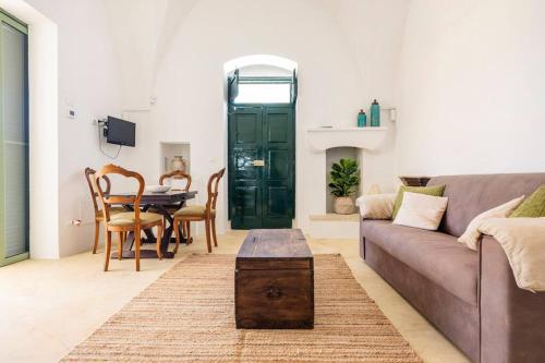 a living room with a couch and a table at The Peak House in Carovigno
