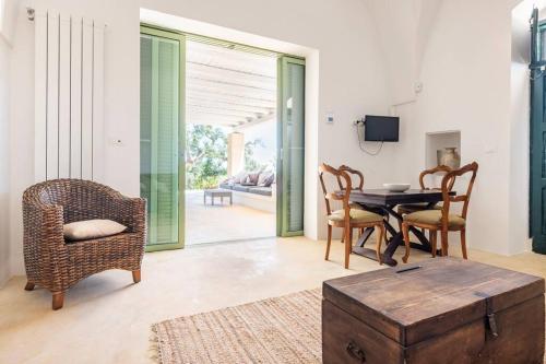 a living room with a table and chairs at The Peak House in Carovigno