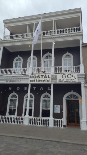 a historic building with a flag in front of it at Gran Casona Hostal in Iquique