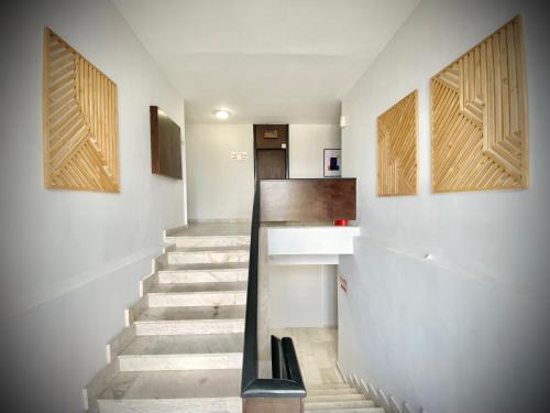 a staircase in a house with wooden doors at Hello Studios Budget Stays Free Parking & Wifi in Stara Zagora