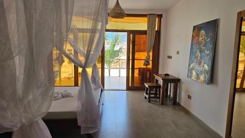 a bathroom with a bed and a window with a view at Sunny Villa Matemwe in Matemwe