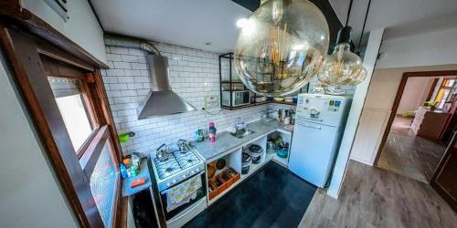 a kitchen with a blue refrigerator and a sink at Pintó Casa Hostel & Bar in Esquel