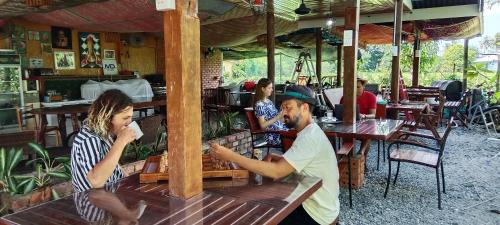 a group of people sitting at a table in a restaurant at Langkawi Country Lodge2 in Pantai Cenang