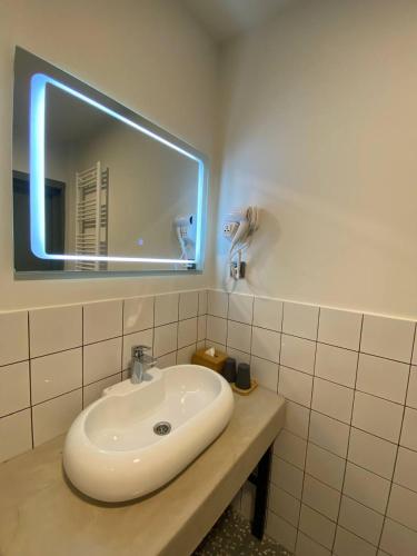 a bathroom with a white sink and a mirror at H2O in Ureki