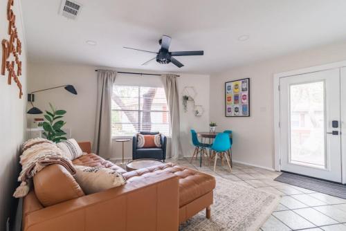 a living room with a couch and a ceiling fan at Downtown Lonestar Bungalow at Beer Ranch Project in Wimberley