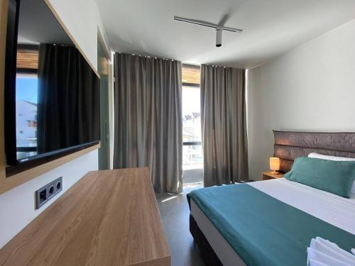 a bedroom with a bed and a large window at H2O in Ureki
