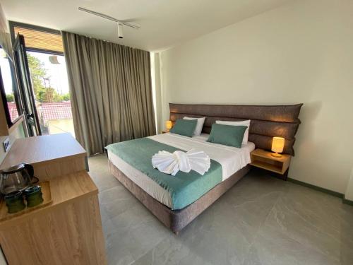 a bedroom with a large bed with green and white sheets at H2O in Ureki