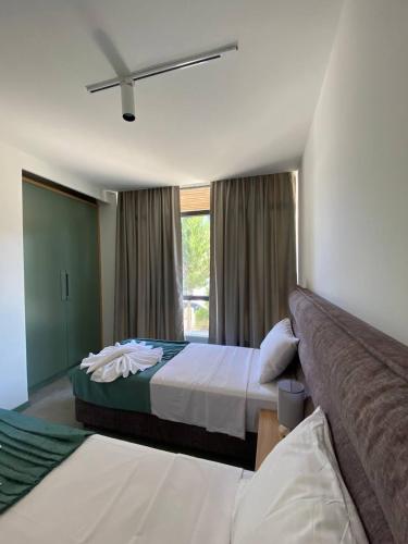 a hotel room with two beds and a window at H2O in Ureki
