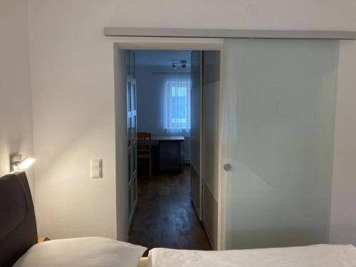 a bedroom with a door leading to a room with a bed at Wohnen im Grünen in Pregarten