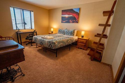 a bedroom with a bed and a ladder in it at Bear Creek Lodge - Spa - Fire Table - 3min to Trails in Colorado Springs