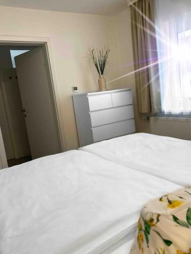 a bedroom with a white bed and a window at Wohnen im Grünen in Pregarten