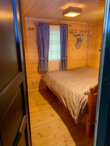 a small bedroom with a bed in a cabin at Three bedroom holiday house with jacuzzi in Bjorli , pets allowed in Bjorli