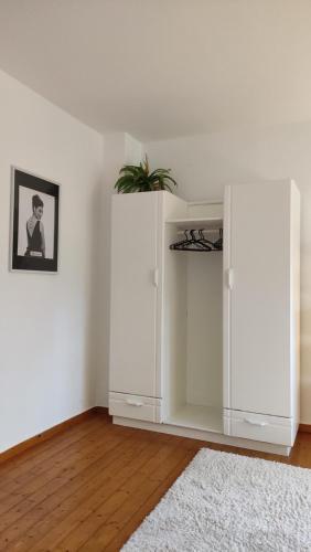 a room with a white cabinet with a plant in it at FeWo im Naturschutzgebiet in Hiddenhausen