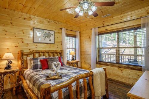 a bedroom with a bed in a log cabin at The Honeycomb Hideaway in Sevierville