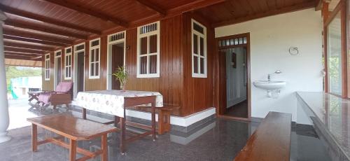 a room with a table and a sink on a house at Koodaram Villa in Vagamon
