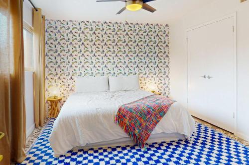 a bedroom with a bed with a patterned wall at South River Condo in Austin
