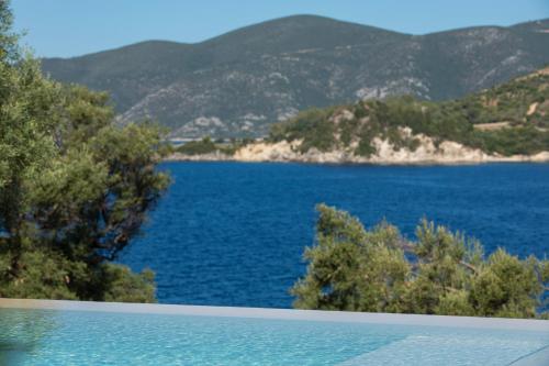 a swimming pool with a view of a body of water at Villa Mironi - Private sea access in Marantochori